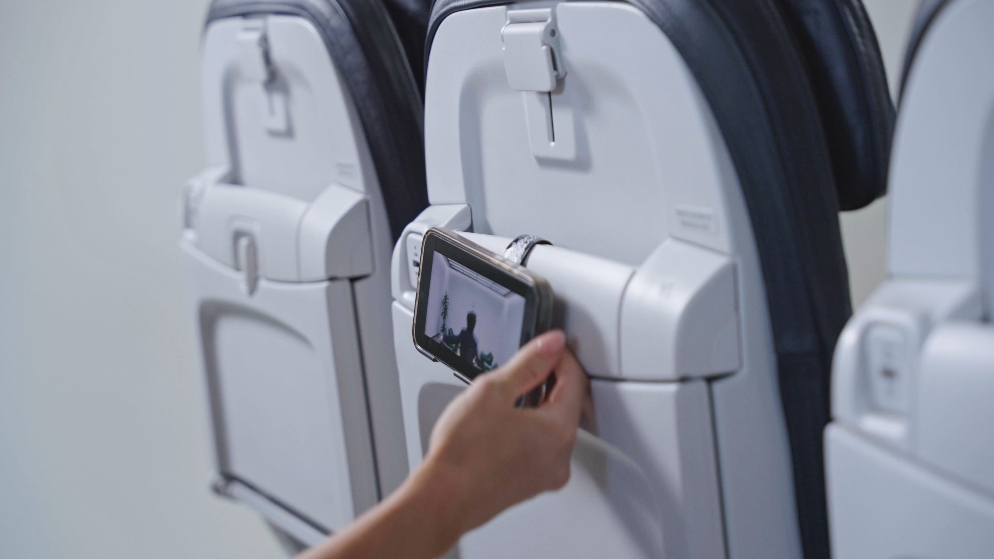 Mo'Bettah band inserted into airplane seat pocket