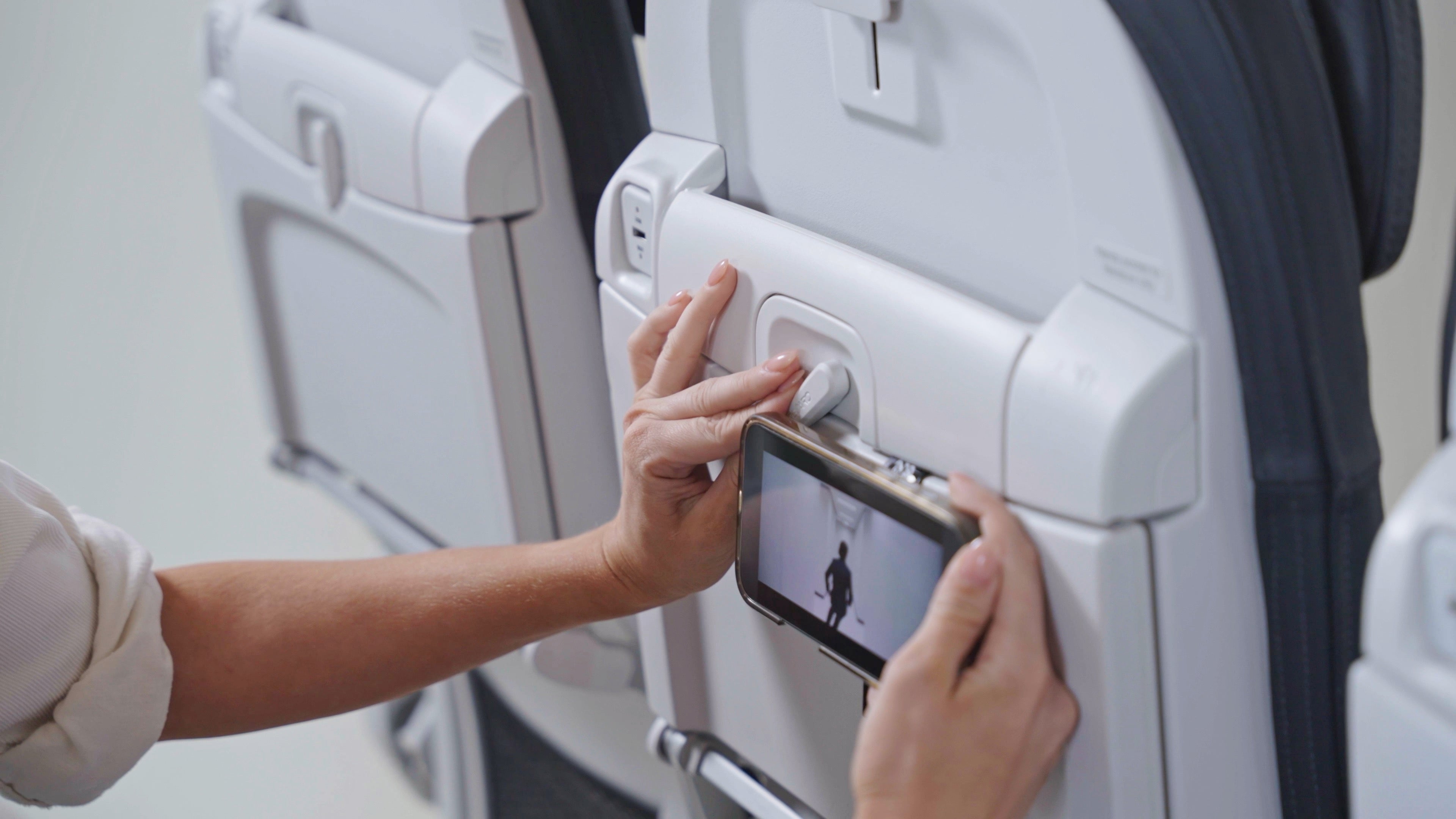 Mo'Bettah airplane phone holder attached to airplane tray table