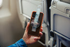 Traveler showing a clear Mo'bettah Airplane Phone Holder on a MagSafe compatible iPhone