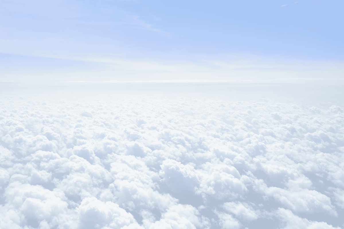 View of clouds from an airplane window with a clear blue sky above.